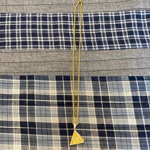 Eye of Horus on gold rope link chain.